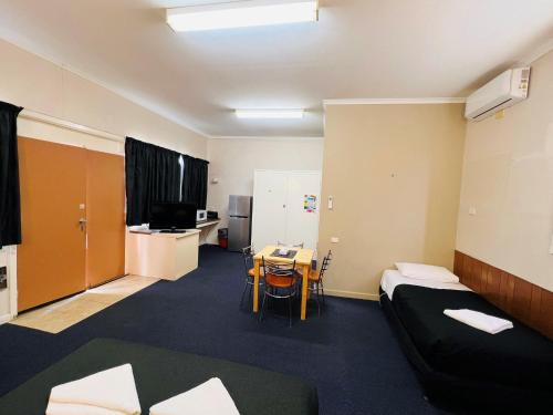 a room with a bed and a table in it at Horsham Motel in Horsham