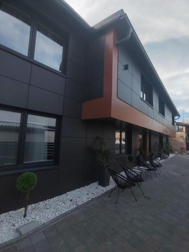 a building with a row of chairs in front of it at APARTMANI VALJEVO in Valjevo