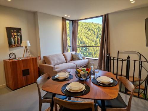 a living room with a table and a couch at Casas de Gondarem by the Douro Valley in Raiva