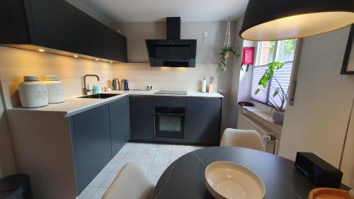 a small kitchen with a table and a sink at Ferienwohnungen Bentheimer Altstadt in Bad Bentheim