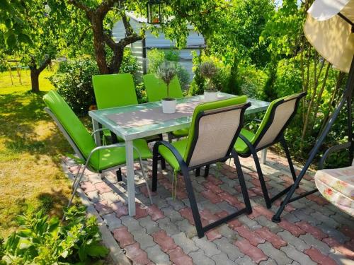 a table and chairs sitting on a brick patio at Fantastic 170m2 Villa with a big garden in Pärnu
