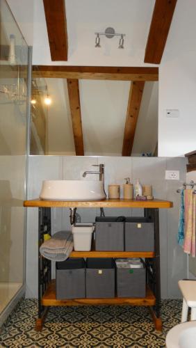 a bathroom with a sink and a counter with boxes at Casa vacanze - alloggio agrituristico Col in Monrupino