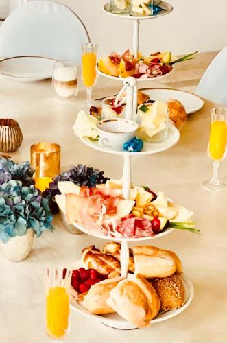 a table topped with plates of food and drinks at Ferienwohnung Honeymoon Deluxe Wellness mit Sauna auf Schloss Falkenhorst in Kleinblittersdorf