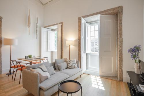 a living room with a couch and a table at Gateway House Studio Apartments in Guimarães