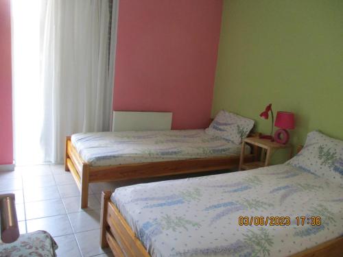 a bedroom with two beds in a room at Anna's Sweet Home Akrata in Paralía Akrátas