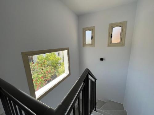 a staircase with a window in a white wall at Villa Marina Sea-View Private Pool in Peyia