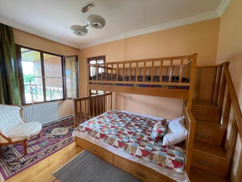 a bedroom with two bunk beds and a chair at Guest House Near Canyon 