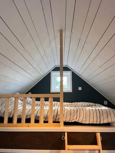 un banco de madera en una habitación con techo en Araya Svensson’s Guest House en Falkenberg