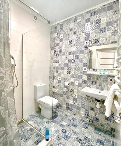 a bathroom with a toilet and a sink and a shower at Friends house bukovel in Bukovel