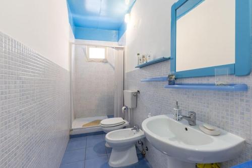 a bathroom with a sink and a toilet and a mirror at Stanze al Capo in Palermo