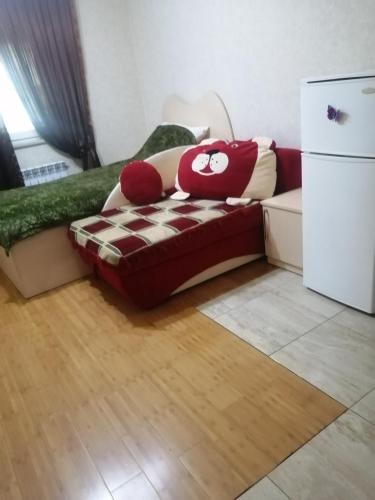 a living room with a couch and a refrigerator at Квартира in Baku