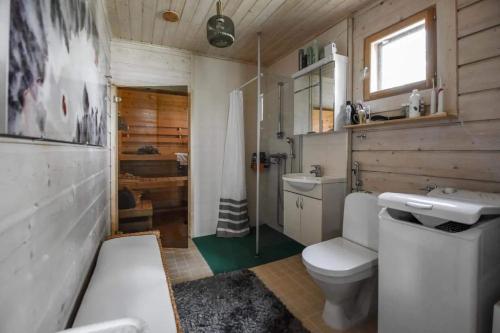 y baño con aseo blanco y lavamanos. en Villa Classic en Ähtäri