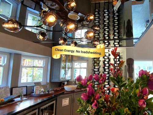 a restaurant with a sign that reads clean energy no breastfeeding at Fleur du Soleil Luxury Guesthouse in Franschhoek