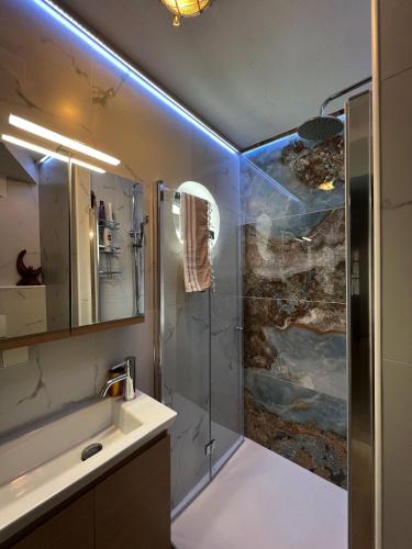 a bathroom with a shower and a sink at Pythagorion Harbour Studio in Pythagoreio