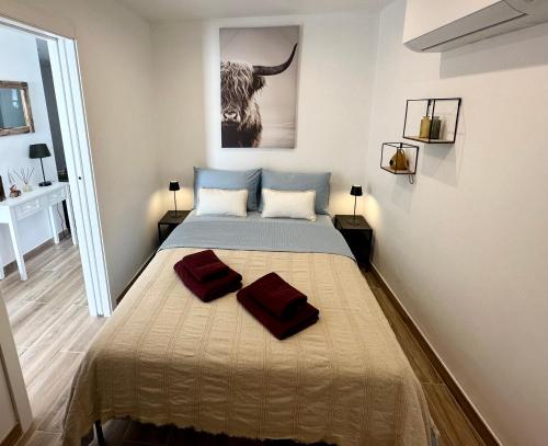 a bedroom with a bed with two pillows on it at Casa Pirilampo Ferragudo in Ferragudo