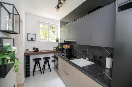 a kitchen with a sink and a counter with stools at BNF Lounge in Varaždin