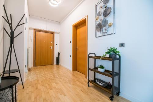 an apartment hallway with a wooden door and wooden floors at BNF Lounge in Varaždin