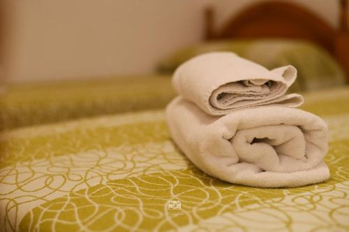 a towel animal sitting on top of a bed at Hospedium Hostal Ben Nassar in Arjona