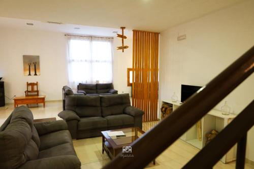 a living room with a couch and a table at Hospedium DLJ Hostal Ben Nassar in Arjona