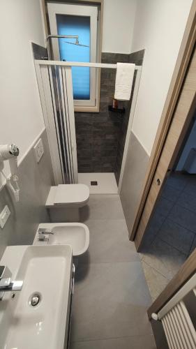 a bathroom with a sink and a toilet and a window at Helianthus Rooms in Lecce