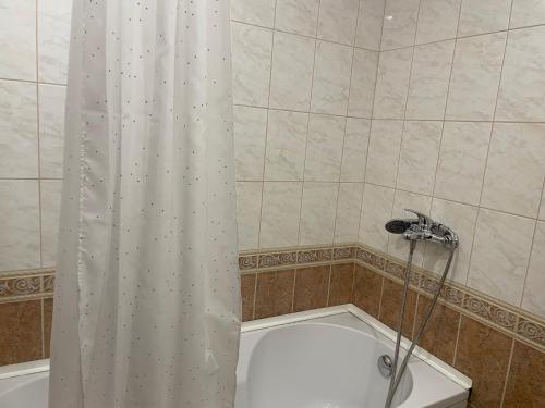 a bathroom with a shower curtain and a toilet at Villa Allegra in Kavarna