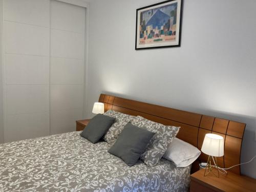 um quarto com uma cama com duas almofadas em La Lúnula by Twelve Apartments VUT3392AS em Gijón