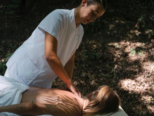 a woman is giving a man a back massage at Hotel Nafarrola - Gastronomy & Wine in Bermeo