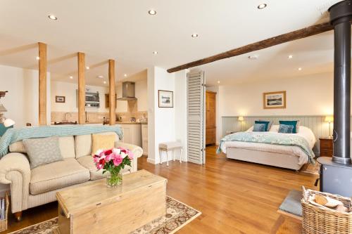 a living room with a bed and a couch at Charcoal House in Coniston