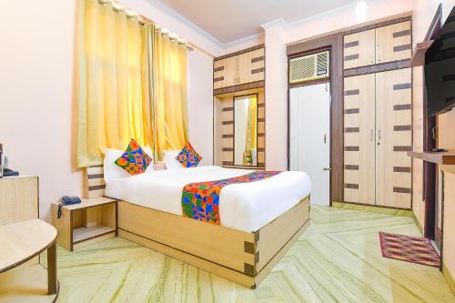 a hotel room with a bed and a television at FabHotel The Grand Kailash in Jaipur