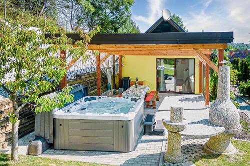 a hot tub in the backyard of a house at Ladybug House With Whirlpool - Happy Rentals in Fokovci