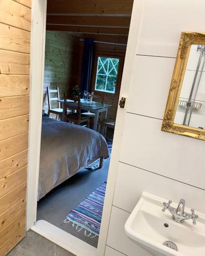 a bathroom with a sink and a bed in a room at Schloss Mörlbach in Icking