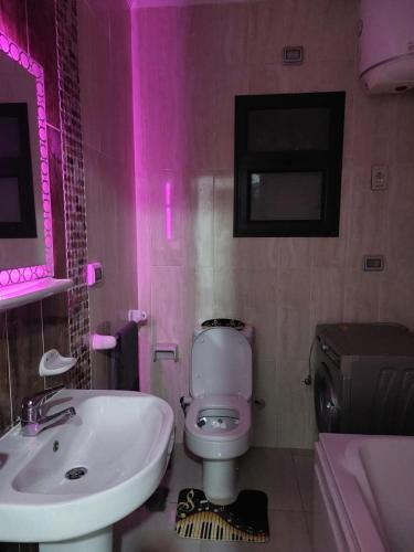 a bathroom with a white toilet and a sink at مدينتي in Madinaty