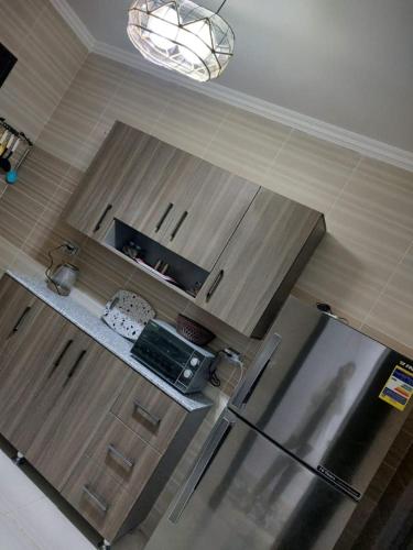 an overhead view of a kitchen with stainless steel appliances at مدينتي in Madinaty