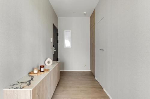 a hallway with white walls and a wooden counter at GRANO HOTEL Solmarina in Wiślinka