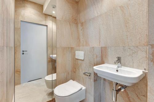 a bathroom with a toilet and a sink at GRANO HOTEL Solmarina in Wiślinka