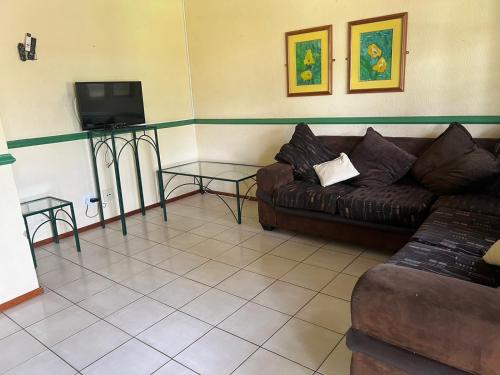 a living room with a couch and a tv at Pendleberry Holiday Resort - Unit 41 in Bela-Bela