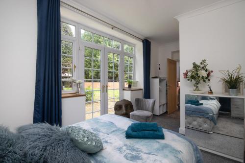 a bedroom with a bed and a large window at No5, One-Bedroom Apartment, Willowbrook House in Bedworth