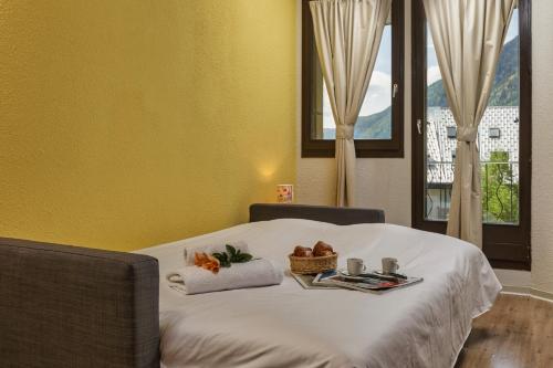 een bed met een dienblad met eten erop bij Chamonix Sud - Bâtiment F 400 - Happy Rentals in Chamonix-Mont-Blanc