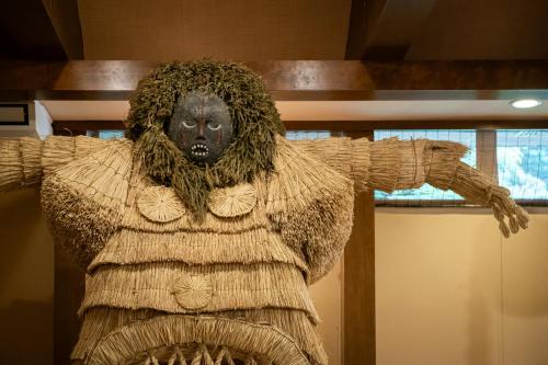a statue of a woman with her arms out at Futari Shizuka in Komagane