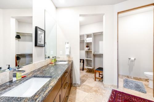 a bathroom with two sinks and a toilet at Red Rock Escape with Suite in St. George