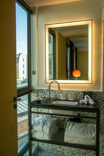 a bathroom with a sink and a mirror at Hôtel Le Ballu in Paris