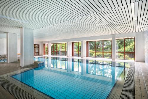 a large swimming pool with a large ceiling at Apartement Bublitz in Travemünde