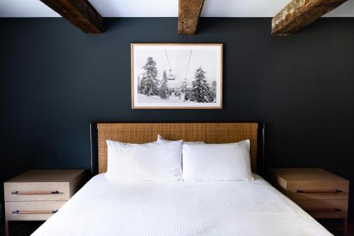 a bedroom with a bed and a picture on the wall at The Lodge at Lincoln Peak at Sugarbush in Warren