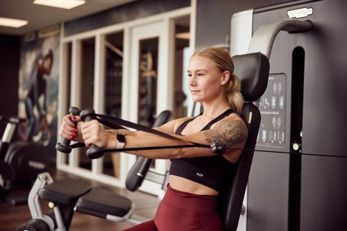 a woman on a treadmill in a gym at Van der Valk hotel Veenendaal in Veenendaal