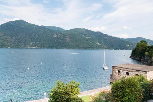 a view of a large body of water with a sail boat at Rivalago B&B in Cannobio