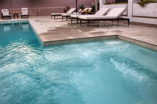 a large pool with blue water in a patio at Villa Vita in Mostar