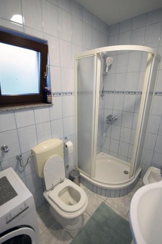 a bathroom with a toilet and a shower and a sink at Villa Vita in Mostar