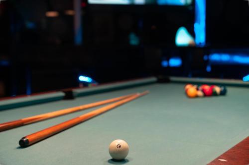 a cue ball and balls on a pool table at City Palace Hotel in Dubai