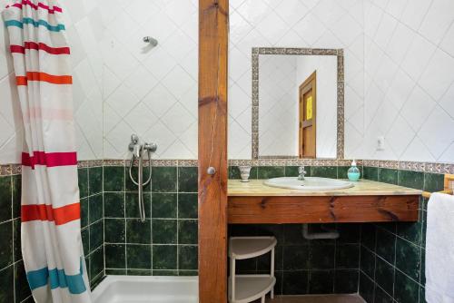 a bathroom with a sink and a tub and a mirror at Casa Mora - Vejer, El Palmar in Vejer de la Frontera