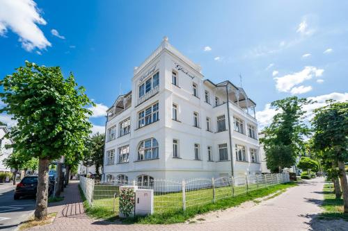 a white building on the side of a street at Strandvilla Glückauf in Binz